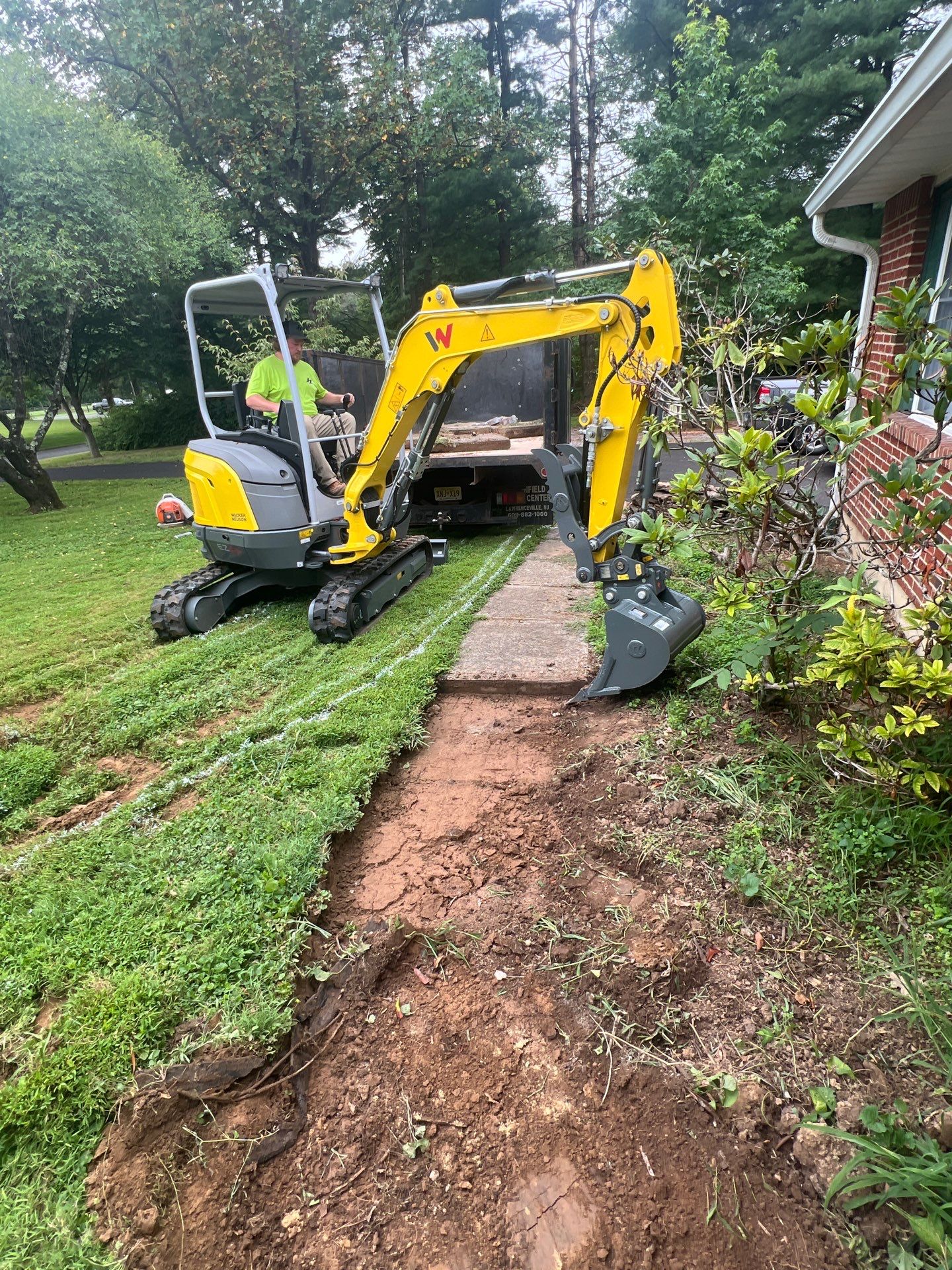Lawn trenching for walkway installation by Hill Landscaping in Tewksbury