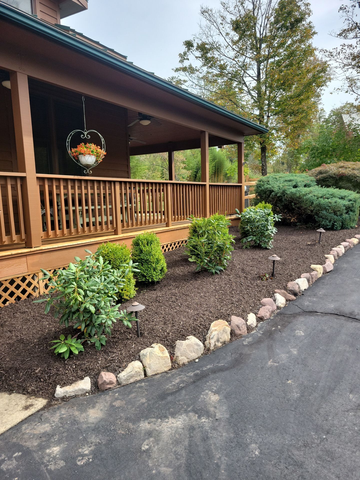 Mulch and shrub maintenance at front porch by Hill Landscaping in Readington Township